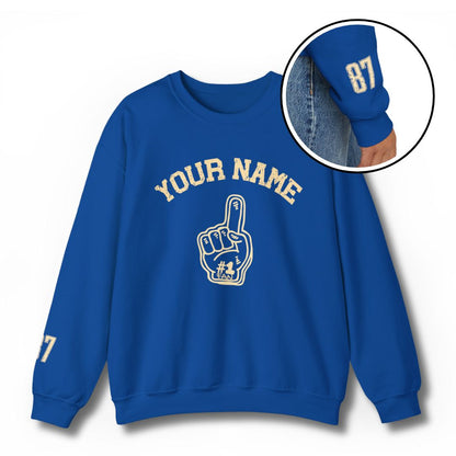 Custom #1 Fan sweatshirt in royal blue with personalized YOUR NAME text and foam finger graphic, featuring player number on sleeve - perfect for sports parents and families showing pride for their young athletes