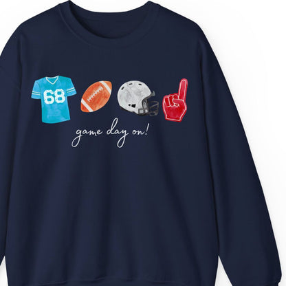 Custom football sweatshirt for football moms with personalized jersey number 68, football, helmet, and foam finger graphics - woman wearing game day apparel at football field holding coffee and football - personalized football parent shirt