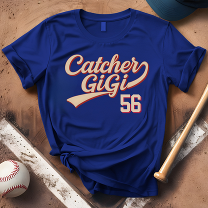 Blue t-shirt with 'Catcher GiGi 56' text on a baseball-themed surface